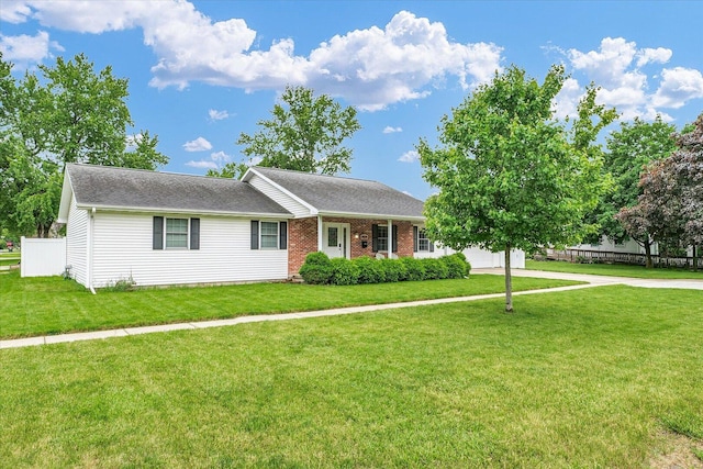 956 E Orleans St, Paxton, IL 60957 - view of front of home with a front lawn, concrete driveway, an attached garage, brick siding, and roof with shingles