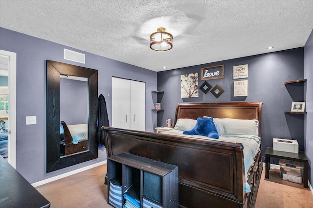 956 E Orleans St, Paxton, IL 60957 - carpeted bedroom with baseboards, a closet, a textured ceiling, and recessed lighting