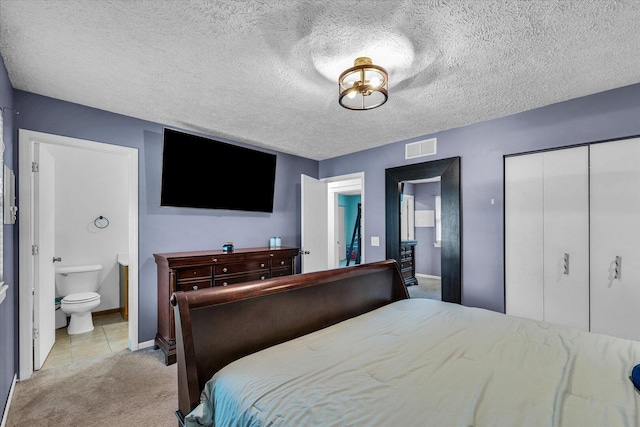 956 E Orleans St, Paxton, IL 60957 - bedroom featuring light carpet, connected bathroom, baseboards, light tile patterned floors, and a textured ceiling