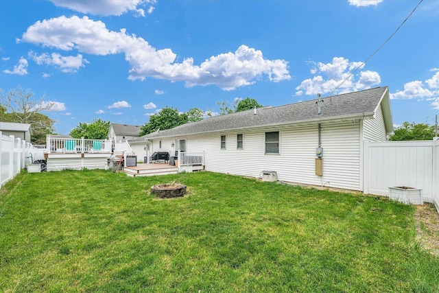 956 E Orleans St, Paxton, IL 60957 - back of property with a fire pit, a wooden deck, and roof with shingles