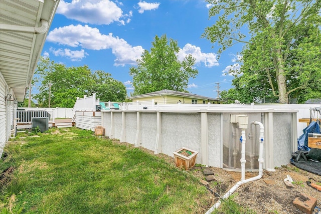 956 E Orleans St, Paxton, IL 60957 - view of green lawn with an outdoor pool, a deck, and cooling unit
