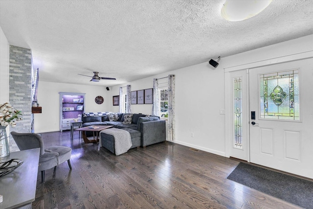956 E Orleans St, Paxton, IL 60957 - living room featuring a textured ceiling, plenty of natural light, wood finished floors, baseboards, and ceiling fan