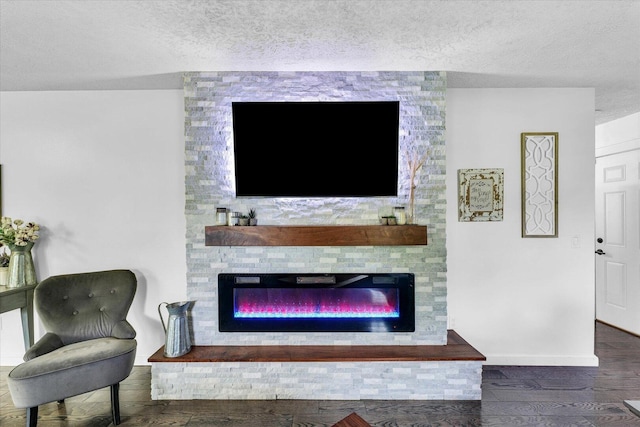 956 E Orleans St, Paxton, IL 60957 - living room featuring a fireplace, a textured ceiling, baseboards, and wood finished floors