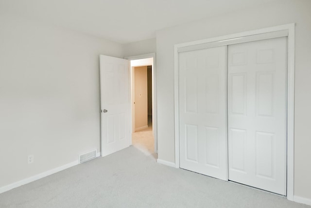 1726 5th Ave, Belvidere, IL 61008 - unfurnished bedroom featuring light carpet, a closet, and baseboards