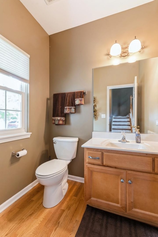 13555 Golden Eagle Cir, Plainfield, IL 60544 - half bathroom with toilet, wood finished floors, vanity, and baseboards
