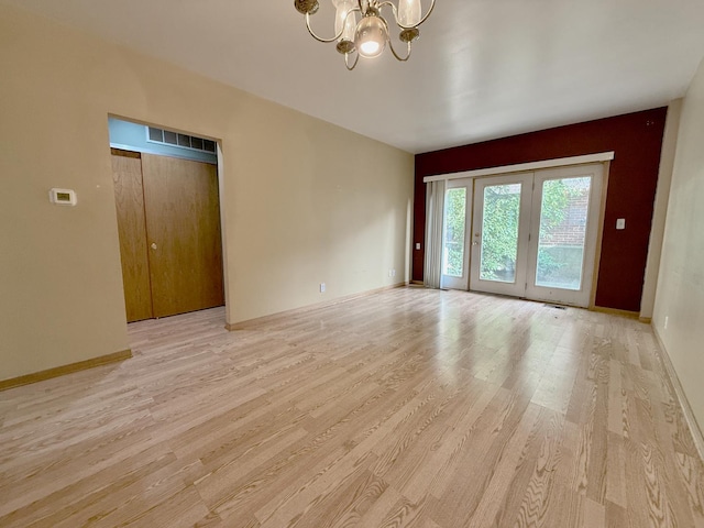 727 S Ashland Ave Unit C, Chicago, IL 60607 - empty room with a chandelier, light wood-type flooring, and baseboards