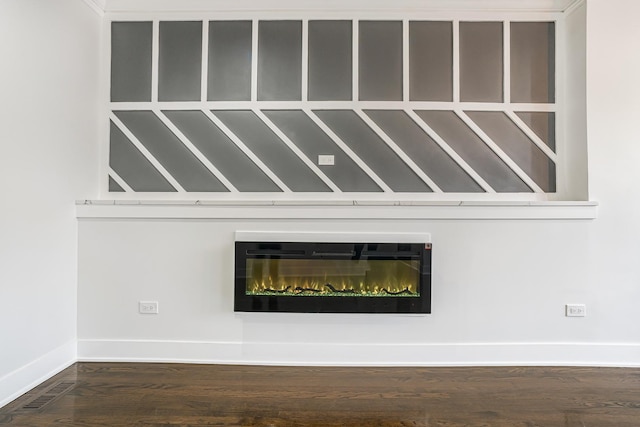 5823 S Francisco Ave, Chicago, IL 60629 - detailed view of baseboards, wood finished floors, and a glass covered fireplace