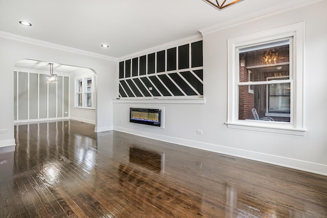 5823 S Francisco Ave, Chicago, IL 60629 - unfurnished living room with arched walkways, a fireplace, hardwood / wood-style floors, ornamental molding, and baseboards
