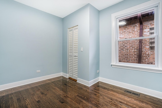 5823 S Francisco Ave, Chicago, IL 60629 - spare room with baseboards and dark wood-style floors