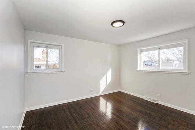 16361 Greenwood Ave, South Holland, IL 60473 - empty room featuring healthy amount of natural light, dark wood-style floors, and baseboards