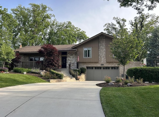 10348 Woburn Ct, Orland Park, IL 60462 - split level home featuring stone siding, concrete driveway, a garage, and a front yard