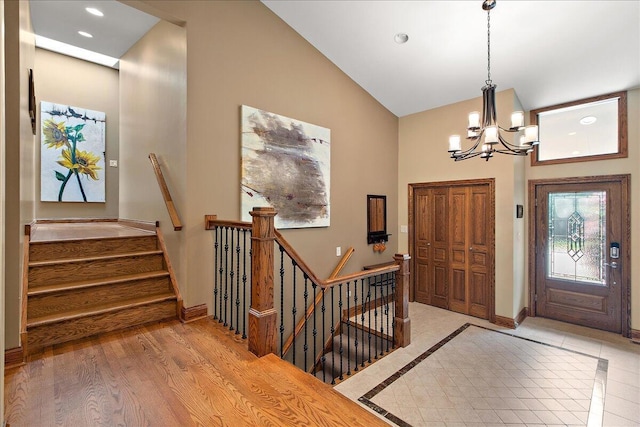 10348 Woburn Ct, Orland Park, IL 60462 - entryway featuring high vaulted ceiling, a chandelier, recessed lighting, and stairway