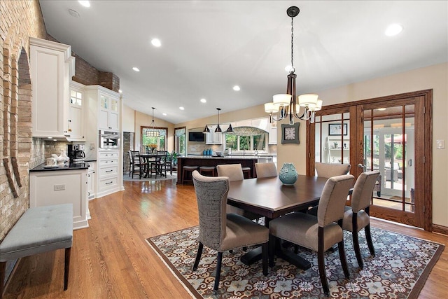 10348 Woburn Ct, Orland Park, IL 60462 - dining room featuring lofted ceiling, a chandelier, light wood-type flooring, and recessed lighting