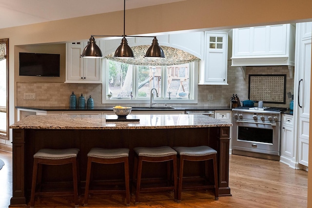 10348 Woburn Ct, Orland Park, IL 60462 - kitchen featuring appliances with stainless steel finishes, a kitchen bar, backsplash, and a kitchen island