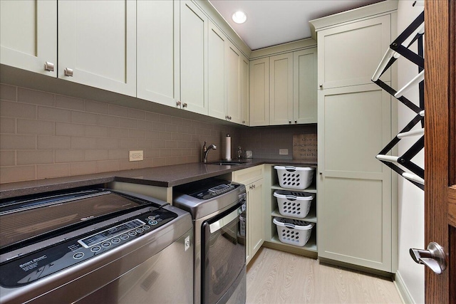 10348 Woburn Ct, Orland Park, IL 60462 - laundry room with independent washer and dryer, light wood-style floors, and cabinet space