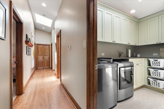 10348 Woburn Ct, Orland Park, IL 60462 - laundry area featuring cabinet space, light wood-style floors, separate washer and dryer, a skylight, and recessed lighting