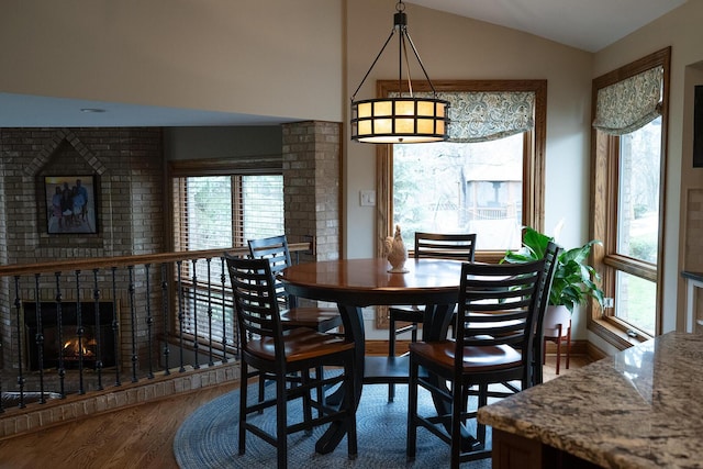 10348 Woburn Ct, Orland Park, IL 60462 - dining room with a brick fireplace, wood finished floors, and vaulted ceiling