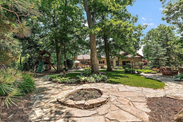 10348 Woburn Ct, Orland Park, IL 60462 - view of grassy yard with a patio, a playground, and a fire pit
