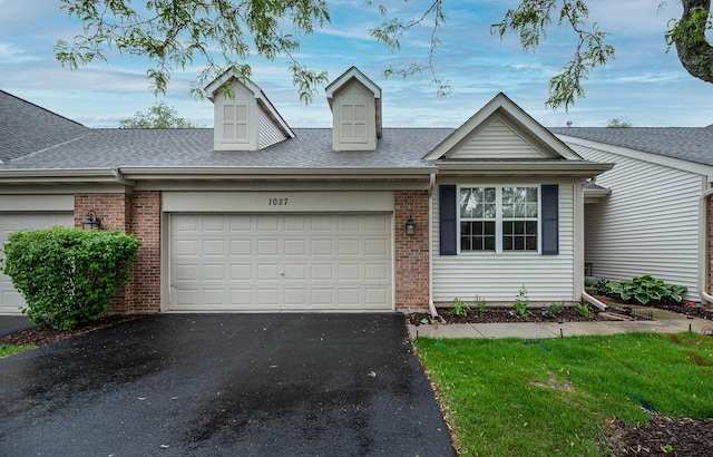 1027 Fairway Dr, Fox Lake, IL 60020 - view of front of home with an attached garage, driveway, a shingled roof, and brick siding