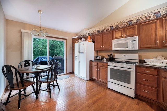 1027 Fairway Dr, Fox Lake, IL 60020 - kitchen featuring white appliances, brown cabinets, dark countertops, a chandelier, and lofted ceiling
