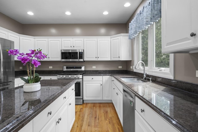 2008 Snow Creek Rd, Naperville, IL 60564 - kitchen featuring appliances with stainless steel finishes, a sink, white cabinetry, light wood-style flooring, and recessed lighting