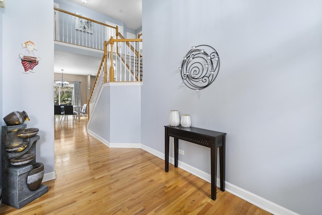 2008 Snow Creek Rd, Naperville, IL 60564 - staircase featuring a chandelier, wood finished floors, baseboards, and a towering ceiling