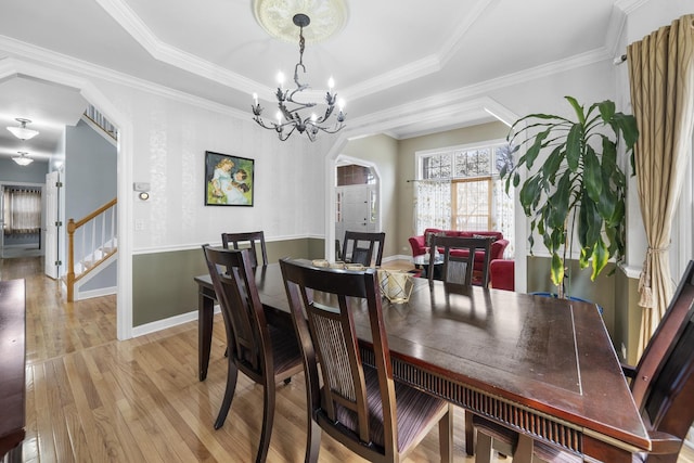 2008 Snow Creek Rd, Naperville, IL 60564 - dining space with light wood-style floors, a chandelier, arched walkways, baseboards, and ornamental molding