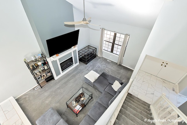 638 Dordan Ct, Gurnee, IL 60031 - carpeted living room with ceiling fan, high vaulted ceiling, marble finish flooring, baseboards, and a glass covered fireplace