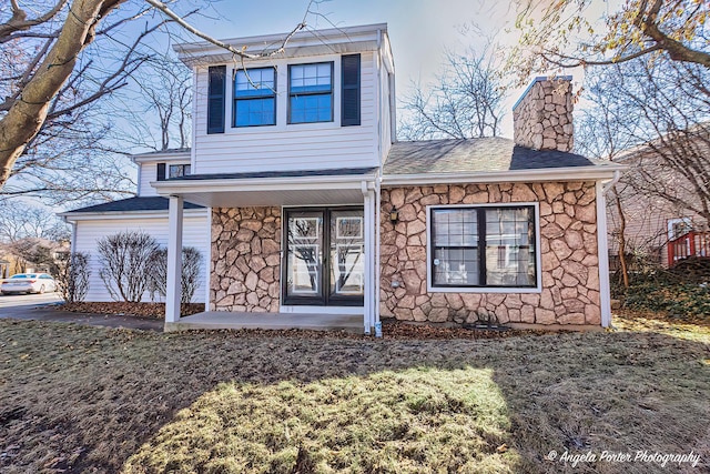 638 Dordan Ct, Gurnee, IL 60031 - view of front of home with stone siding, a chimney, and covered porch