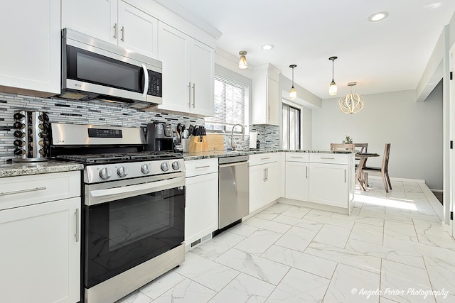 638 Dordan Ct, Gurnee, IL 60031 - kitchen with appliances with stainless steel finishes, light marble finish floors, white cabinets, tasteful backsplash, and light stone countertops