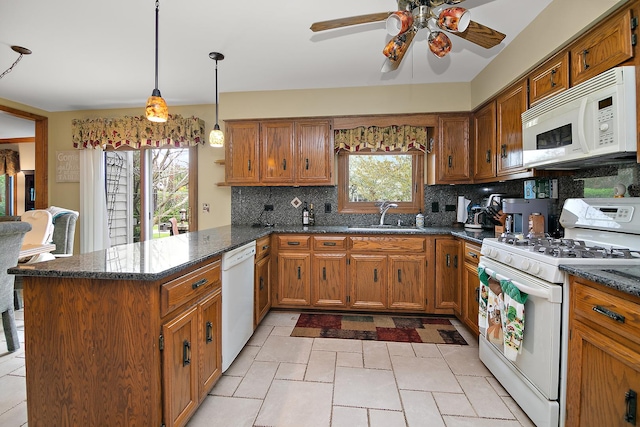 454 Hemlock Ln, Roselle, IL 60172 - kitchen featuring white appliances, a sink, a peninsula, and brown cabinetry