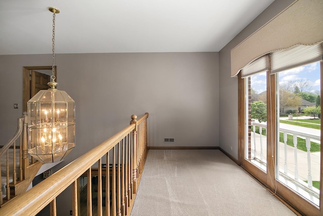 454 Hemlock Ln, Roselle, IL 60172 - hall featuring a chandelier, carpet floors, and baseboards