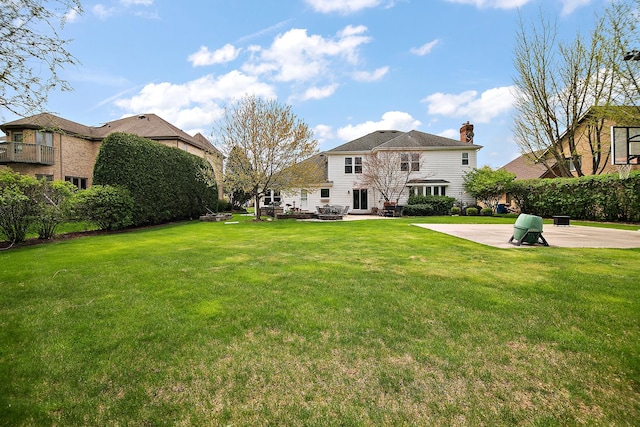 454 Hemlock Ln, Roselle, IL 60172 - rear view of house featuring a chimney, a lawn, and a patio