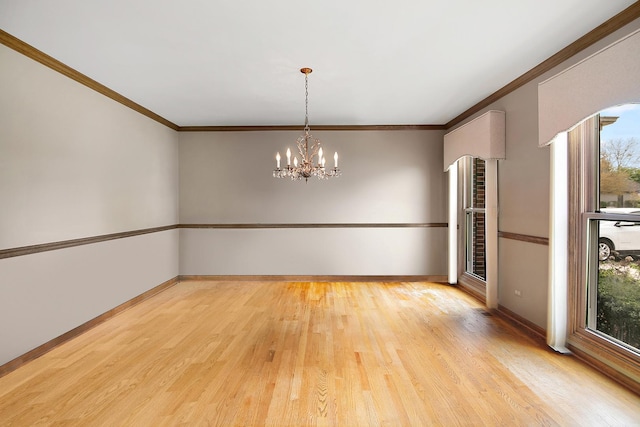 454 Hemlock Ln, Roselle, IL 60172 - empty room with healthy amount of natural light, wood finished floors, a chandelier, baseboards, and crown molding