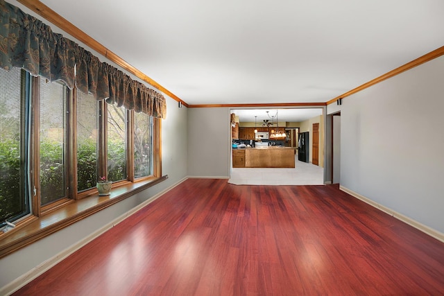 454 Hemlock Ln, Roselle, IL 60172 - unfurnished living room featuring a chandelier, wood finished floors, ornamental molding, and baseboards
