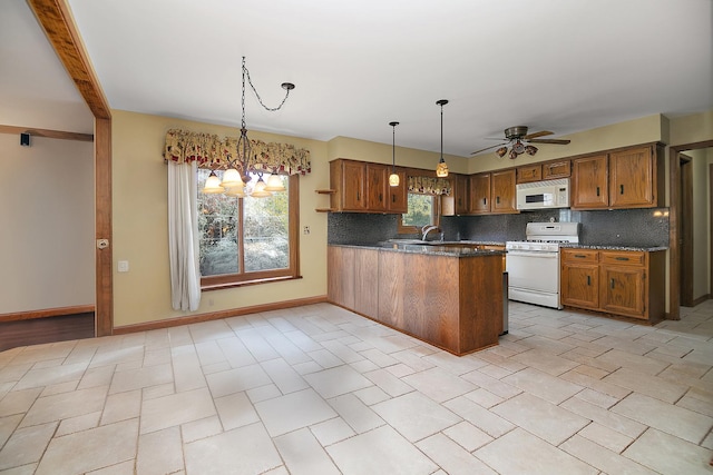 454 Hemlock Ln, Roselle, IL 60172 - kitchen featuring white appliances, brown cabinetry, a peninsula, and tasteful backsplash