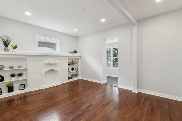 8019 S Bishop St, Chicago, IL 60620 - unfurnished living room featuring wood finished floors, baseboards, a brick fireplace, recessed lighting, and built in shelves