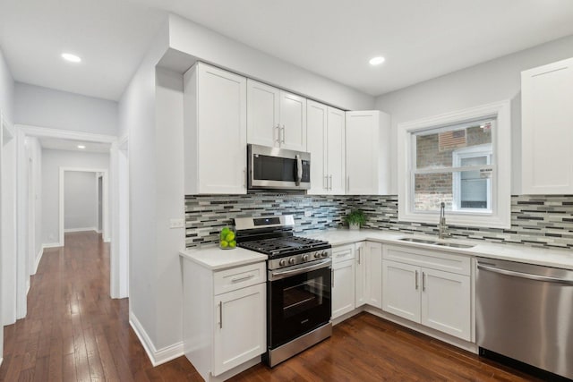 8019 S Bishop St, Chicago, IL 60620 - kitchen with stainless steel appliances, a sink, light countertops, backsplash, and white cabinetry