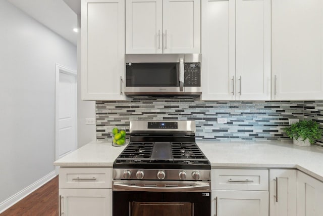 8019 S Bishop St, Chicago, IL 60620 - kitchen with stainless steel appliances, white cabinetry, dark wood-style floors, and tasteful backsplash
