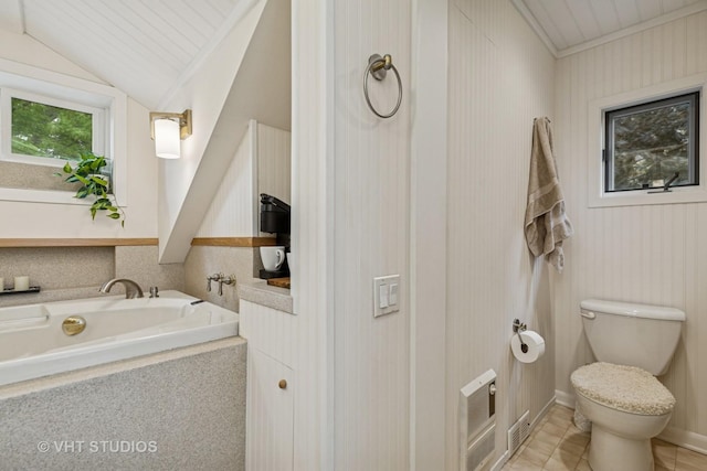 18 N Lake Ave, Fox Lake, IL 60020 - bathroom featuring a bath, vaulted ceiling, toilet, and tile patterned floors