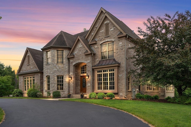 28809 W Harvest Glen Cir, Cary, IL 60013 - french country home with a front yard, brick siding, and a standing seam roof