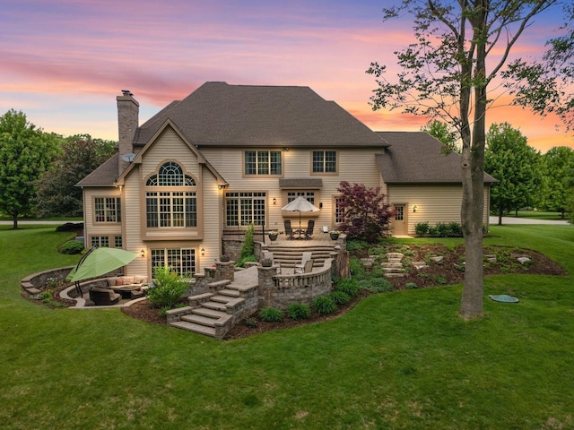 28809 W Harvest Glen Cir, Cary, IL 60013 - back of property with a patio area, a lawn, a chimney, and a shingled roof