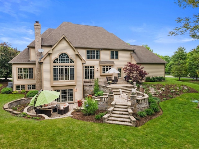 28809 W Harvest Glen Cir, Cary, IL 60013 - rear view of property featuring outdoor lounge area, a patio, a chimney, a yard, and a shingled roof