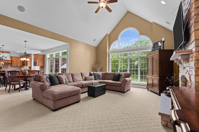 28809 W Harvest Glen Cir, Cary, IL 60013 - living area featuring a stone fireplace, a ceiling fan, healthy amount of natural light, high vaulted ceiling, and a chandelier