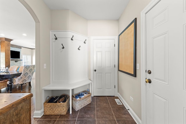 12923 Grande Pines Blvd, Plainfield, IL 60585 - mudroom with arched walkways, baseboards, and dark tile patterned flooring