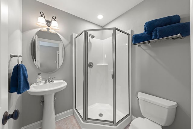 12923 Grande Pines Blvd, Plainfield, IL 60585 - bathroom featuring baseboards, a shower stall, toilet, and tile patterned floors