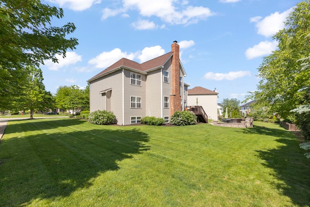12923 Grande Pines Blvd, Plainfield, IL 60585 - rear view of property with a chimney and a lawn