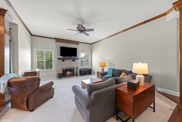 12923 Grande Pines Blvd, Plainfield, IL 60585 - living room with ceiling fan, a stone fireplace, crown molding, baseboards, and light carpet