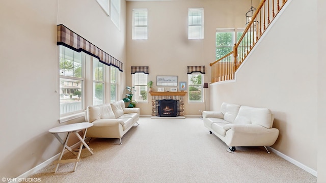 296 Huron St, Vernon Hills, IL 60061 - carpeted living area with baseboards, a high ceiling, stairs, and a brick fireplace