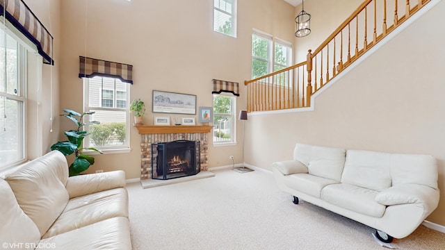 296 Huron St, Vernon Hills, IL 60061 - carpeted living room featuring a towering ceiling, baseboards, a fireplace, and stairs